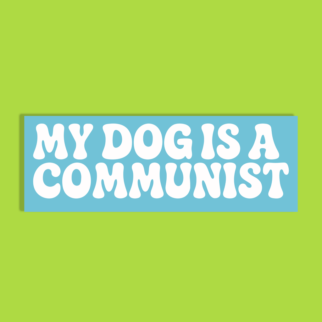 A rectangular blue background with the text 'MY DOG IS A COMMUNIST' in bold white rounded letters, shown against a solid lime green backdrop.