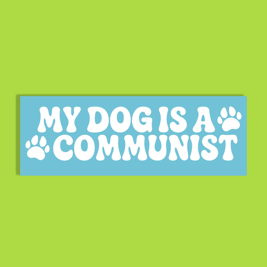 A rectangular light blue background and bold white text reading 'MY DOG IS A COMMUNIST' with two paw prints, shown on a solid lime green background.