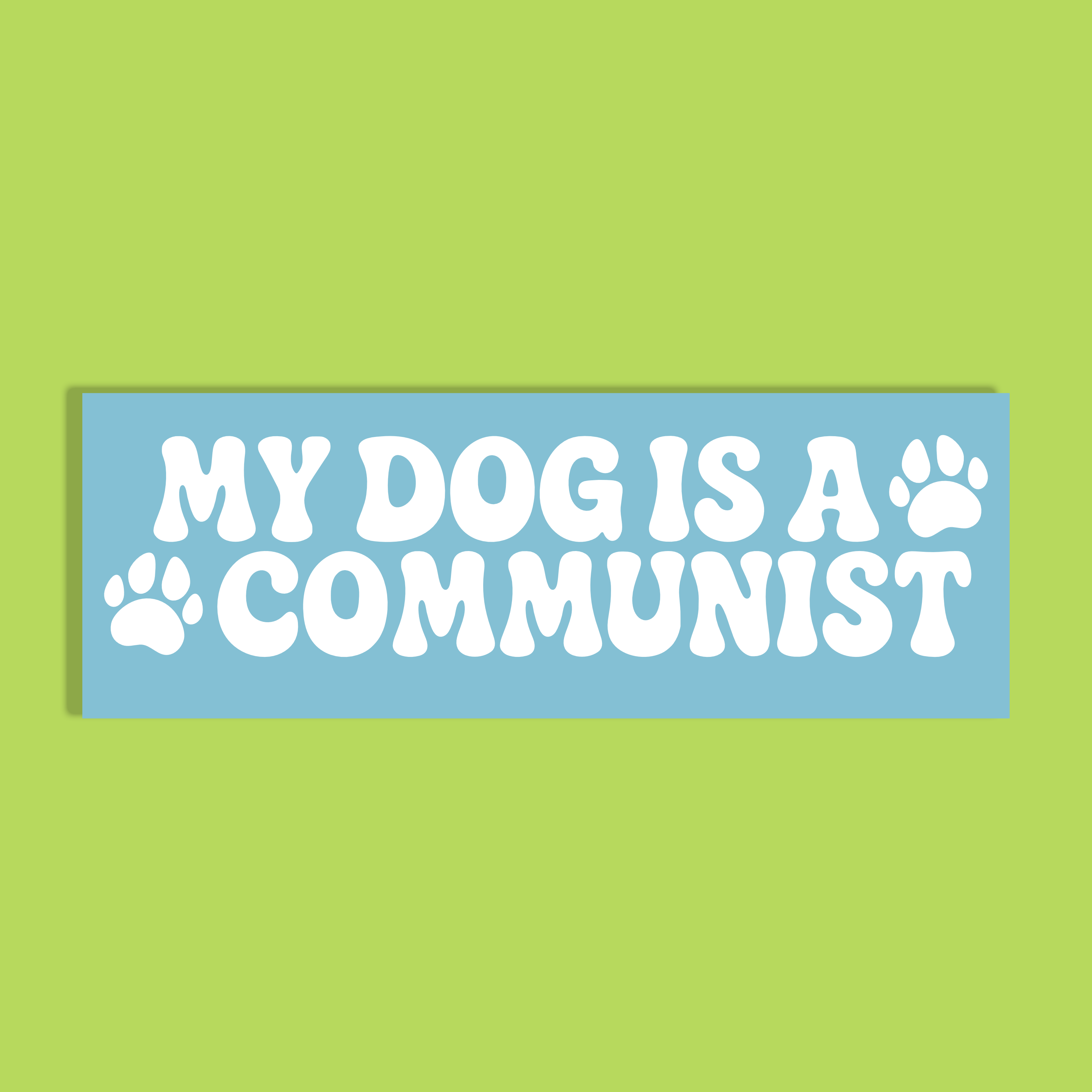 A rectangular light blue background and bold white text reading 'MY DOG IS A COMMUNIST' with two paw prints, shown on a solid lime green background.