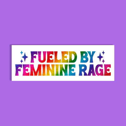 A white rectangle with the phrase 'FUELED BY FEMININE RAGE' in glittery rainbow letters, shown on a solid purple background.