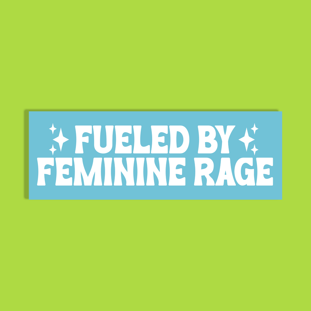 A light blue rectangle with bold white text reading 'FUELED BY FEMININE RAGE' with small star accents, shown on a solid lime green background.