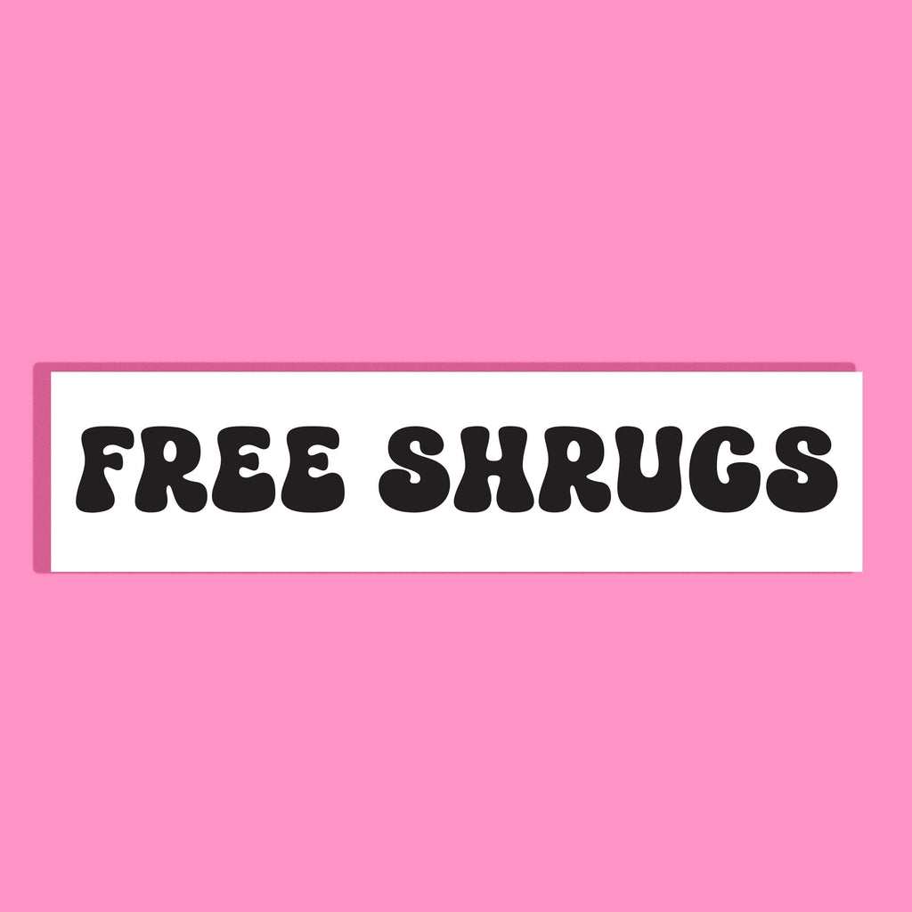 A rectangular white background with the words 'FREE SHRUGS' in bold black retro lettering, centered on a solid pink background.