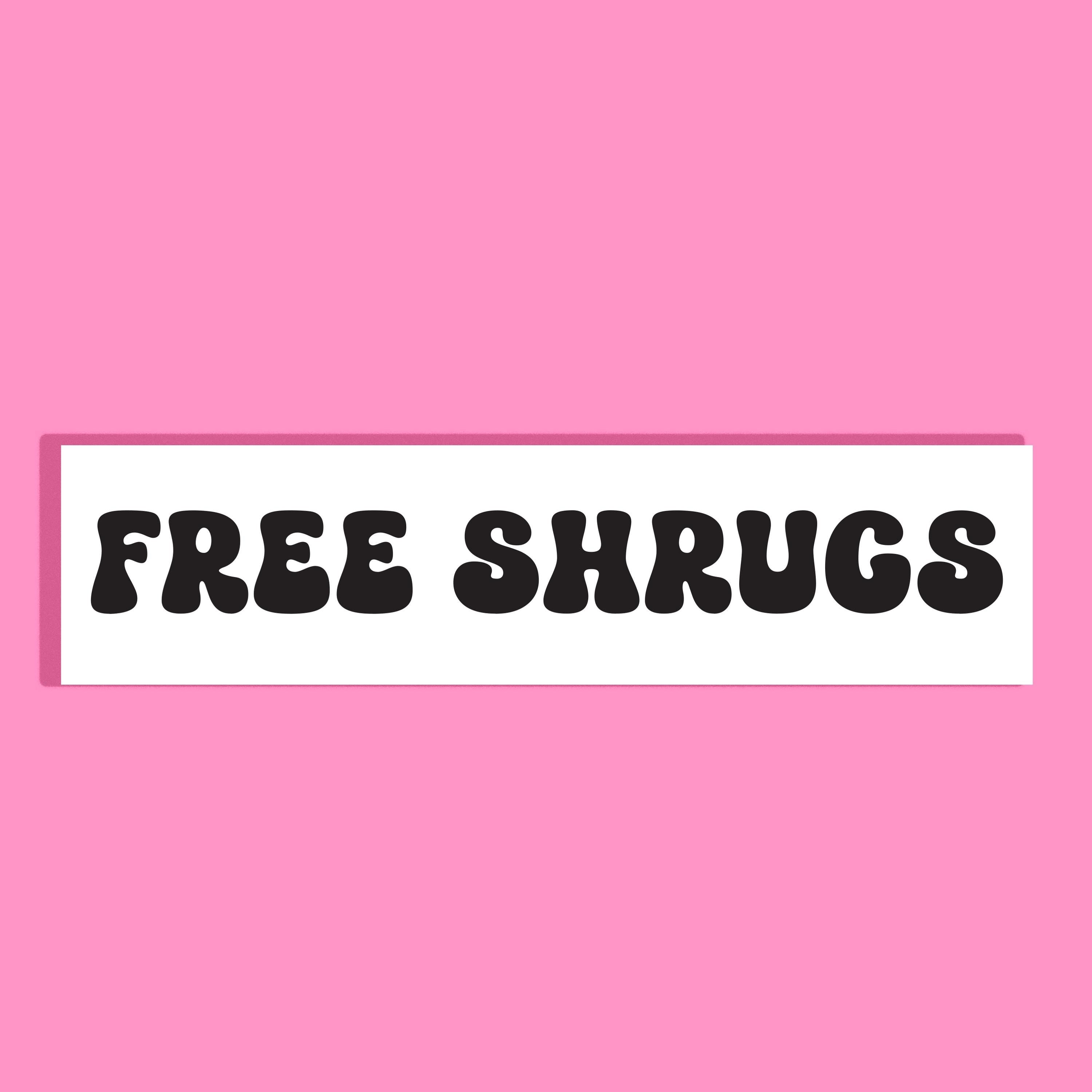 A rectangular white background with the words 'FREE SHRUGS' in bold black retro lettering, centered on a solid pink background.