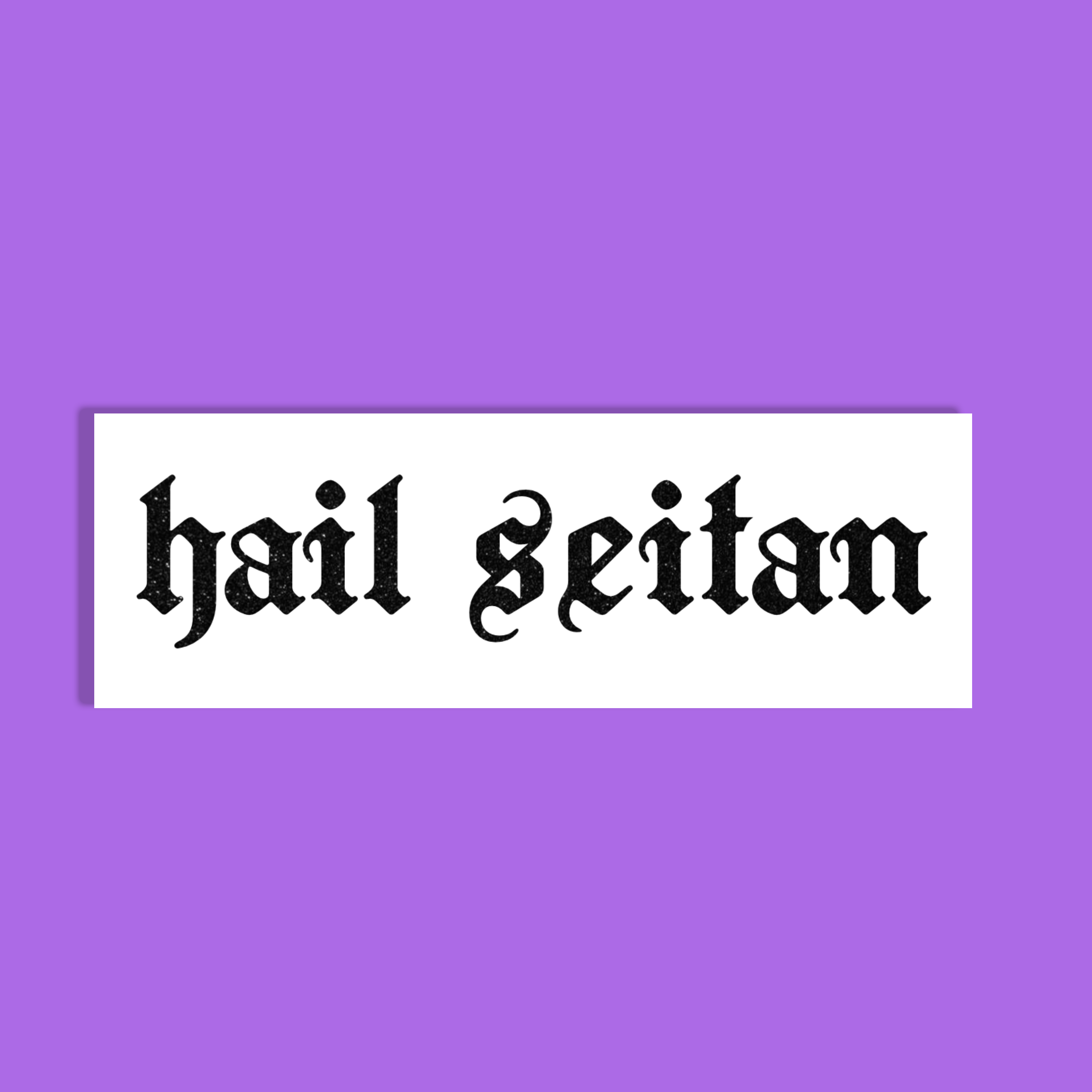A white rectangular sticker or sign with the phrase 'hail seitan' in black gothic-style lettering, centered on a solid purple background.