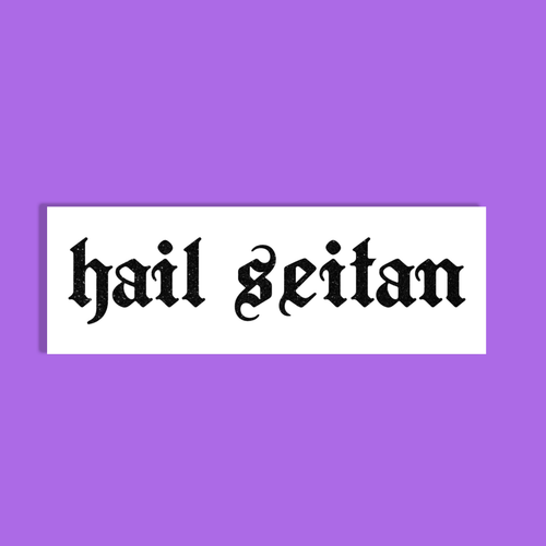 A white rectangular sticker or sign with the phrase 'hail seitan' in black gothic-style lettering, centered on a solid purple background.