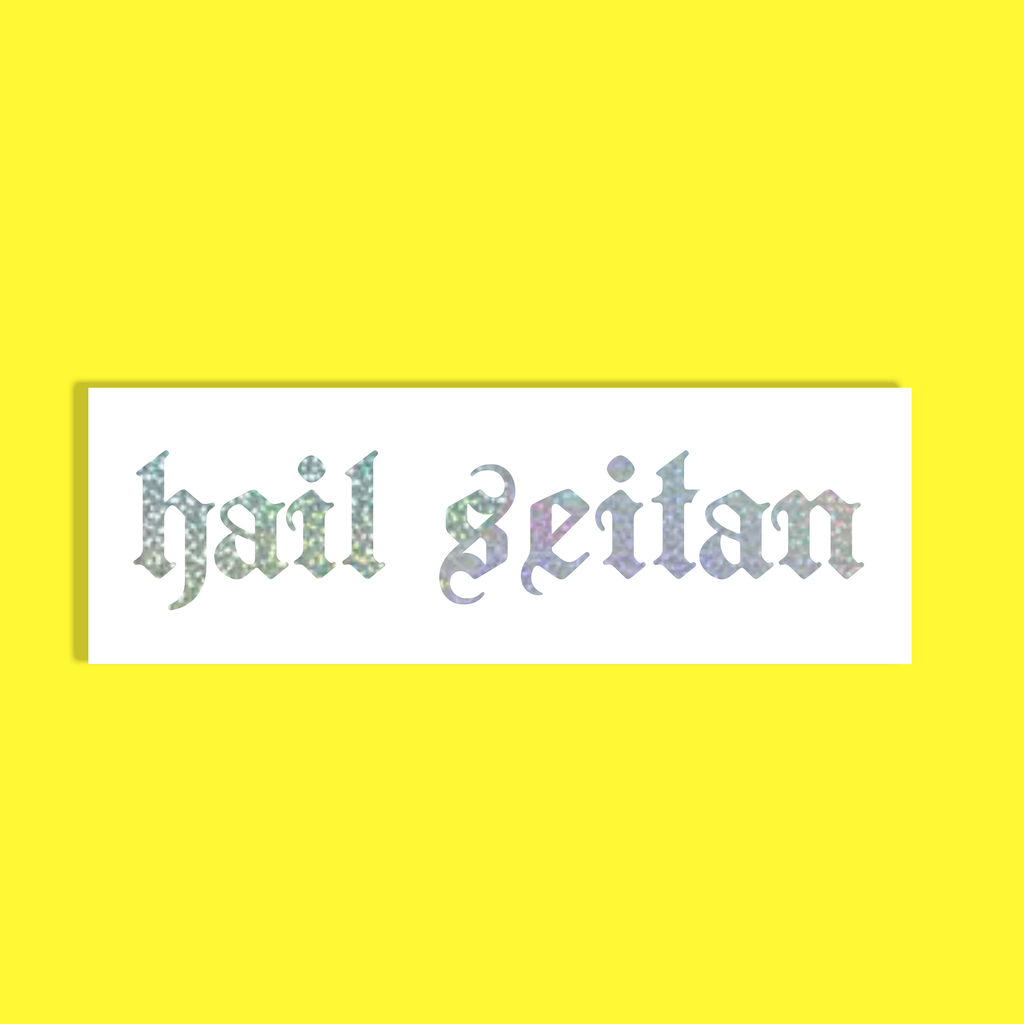 A rectangular white background with the phrase 'hail seitan' in a decorative, textured silver and iridescent font, centered on a solid bright yellow background.