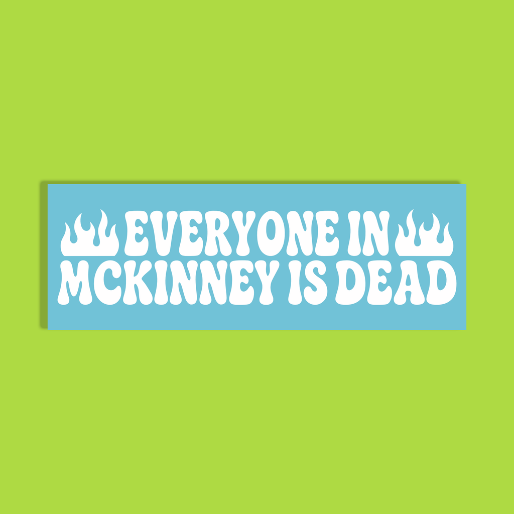 A rectangular light blue sticker or sign with bold white text reading 'EVERYONE IN MCKINNEY IS DEAD' and flame icons on the sides, centered on a bright lime green background.