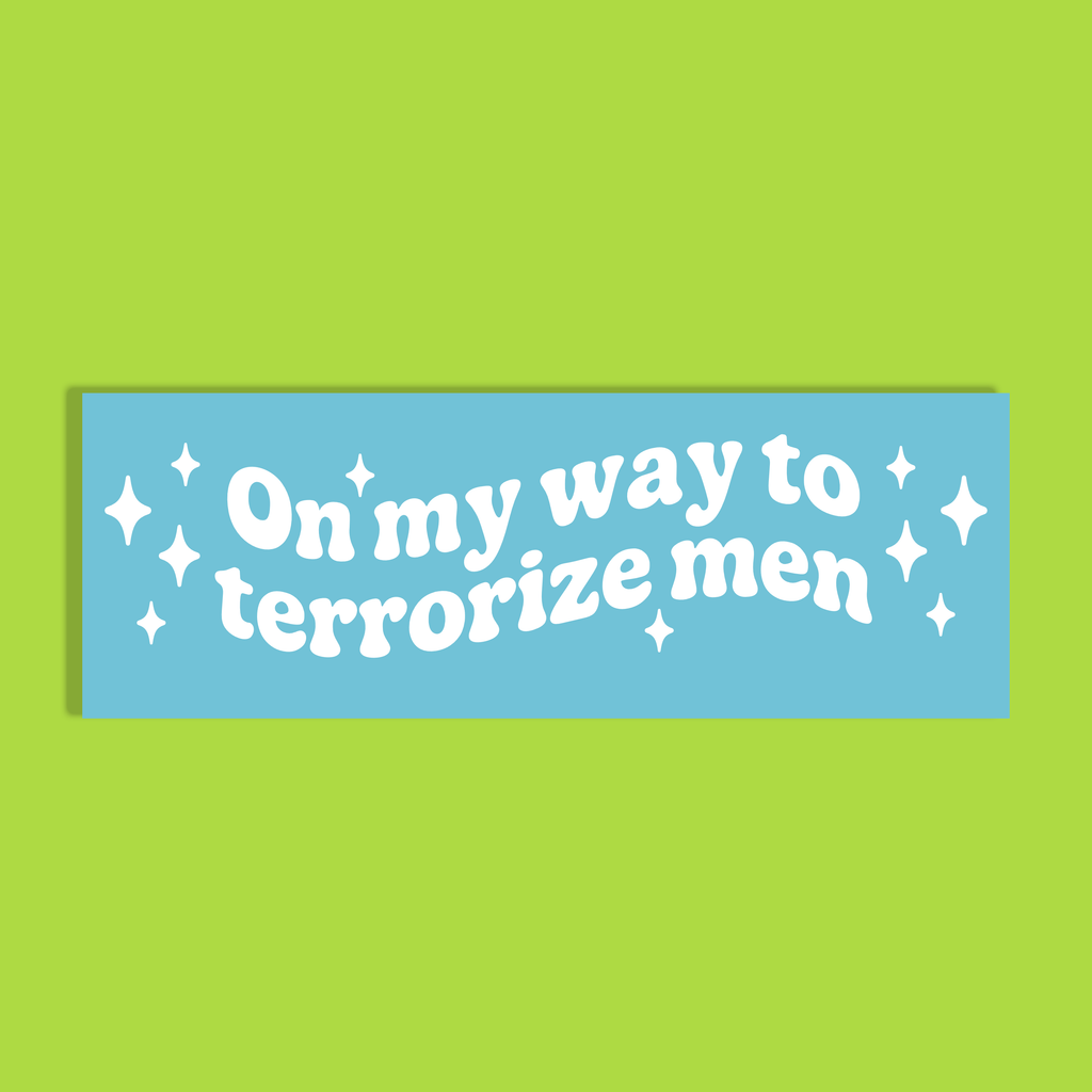 A rectangular light blue background with the phrase 'On my way to terrorize men' in white retro-style lettering, accented with small white stars, shown on a solid lime green background.