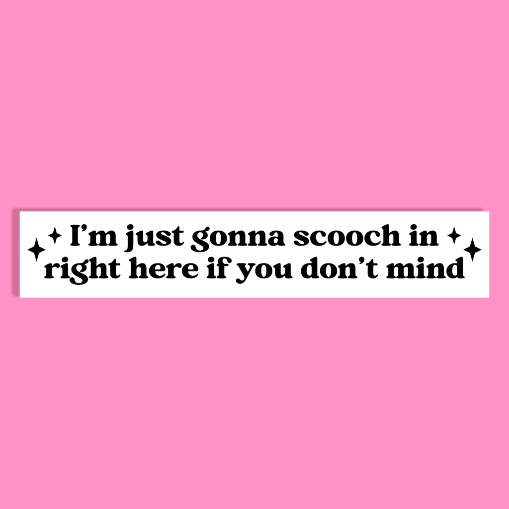 A white rectangle with black text reading 'I'm just gonna scooch in right here if you don't mind' and small black sparkle accents, shown on a solid pink background.