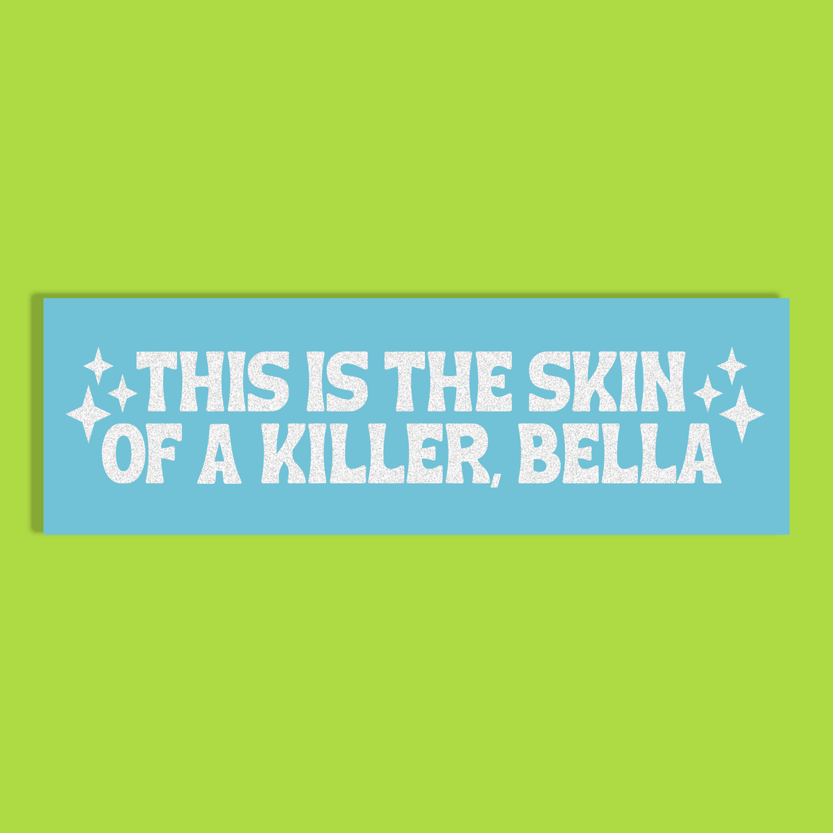 A rectangular light blue background with white glittery text reading 'THIS IS THE SKIN OF A KILLER, BELLA' and small white sparkle graphics, shown on a solid lime green background.