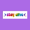 A rectangular white background with the phrase 'stay alive' in rainbow glitter-style lettering, centered on a solid purple background.