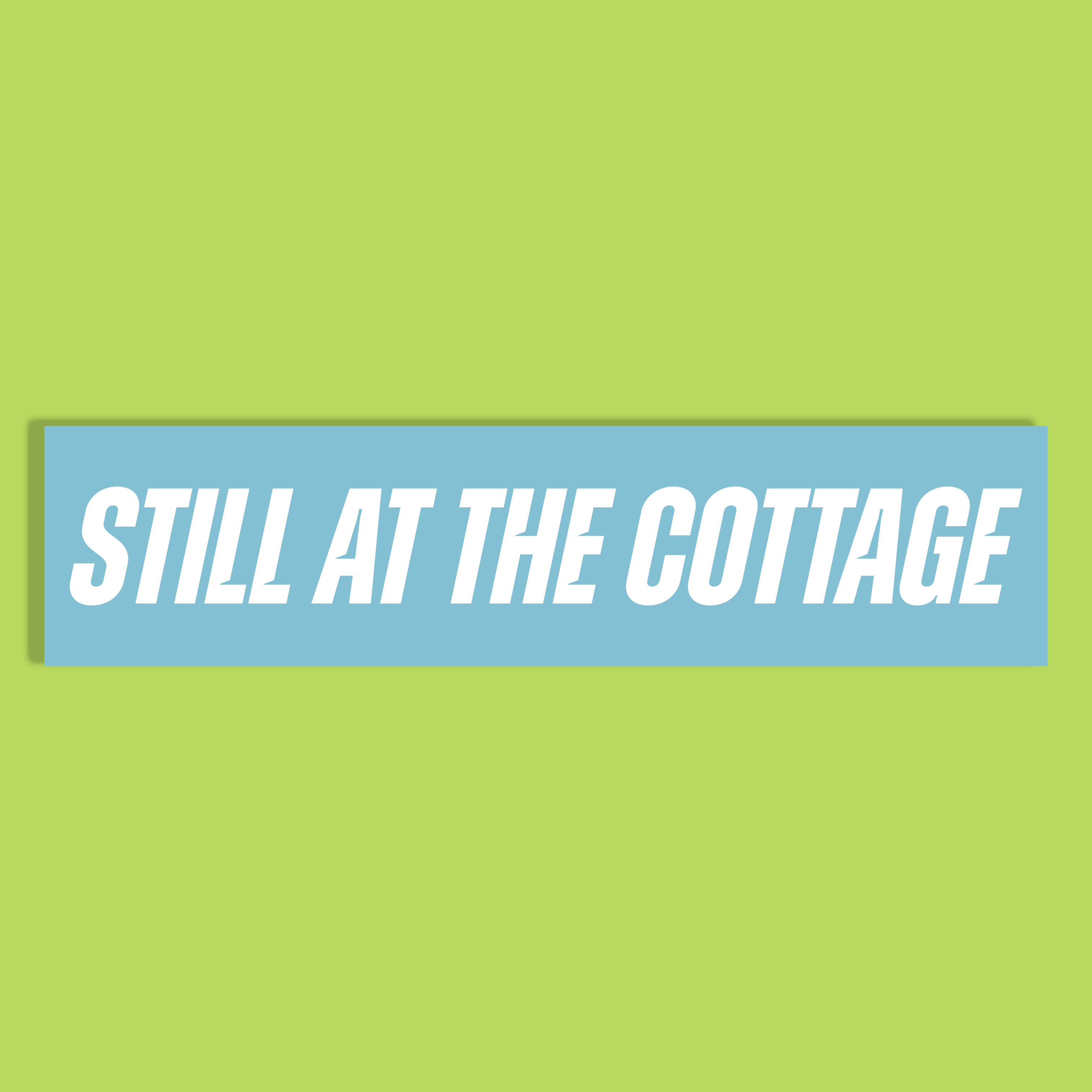 The text 'STILL AT THE COTTAGE' in white bold letters on a light blue background, shown against a solid lime green backdrop.